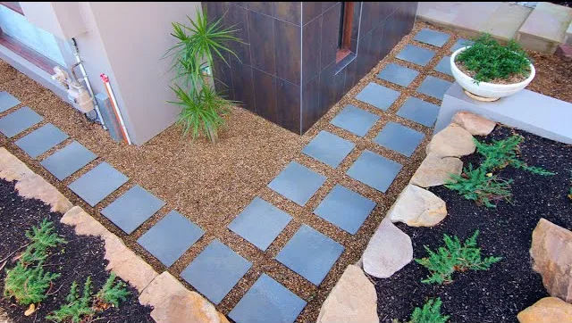 Geometric stepping-stone paths across a landscaped courtyard