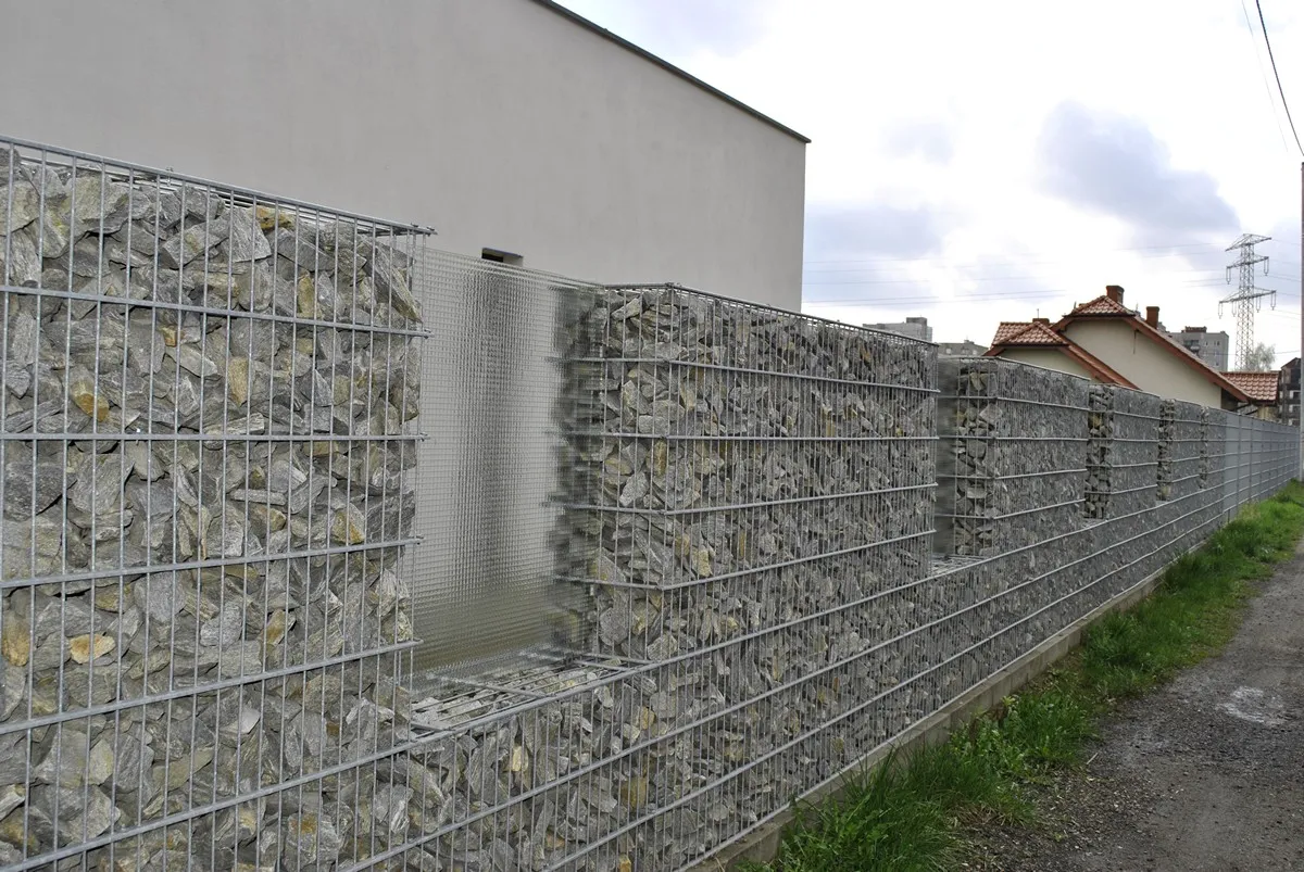 Long gabion boundary fence under construction