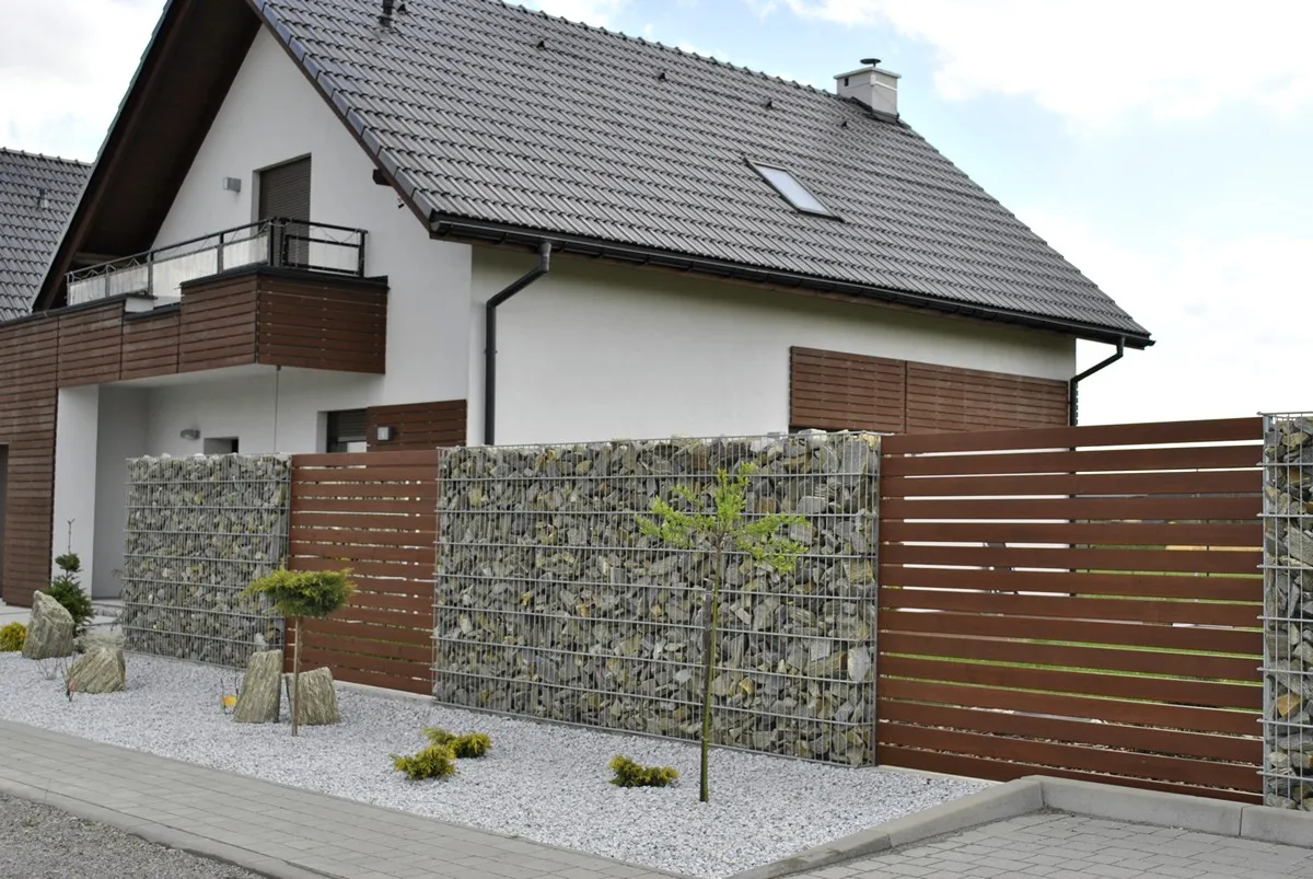 Gabion fence with timber-look sliding gate panels